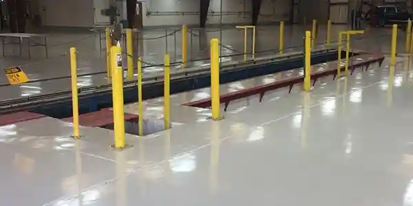 A warehouse with yellow posts and a ramp.